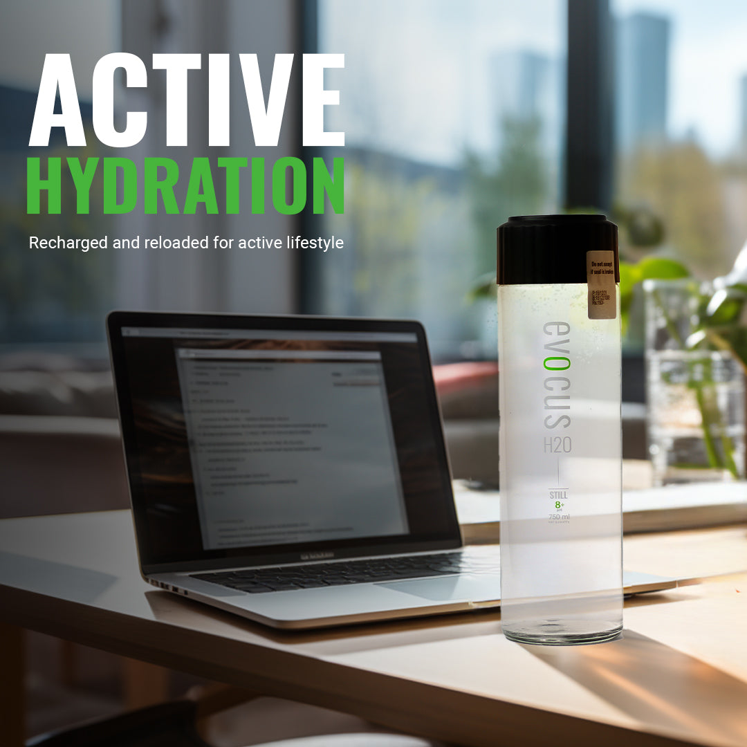 Evocus Alkaline glass Water bottle on a desk with a laptop, promoting "Active Hydration" for an active lifestyle.